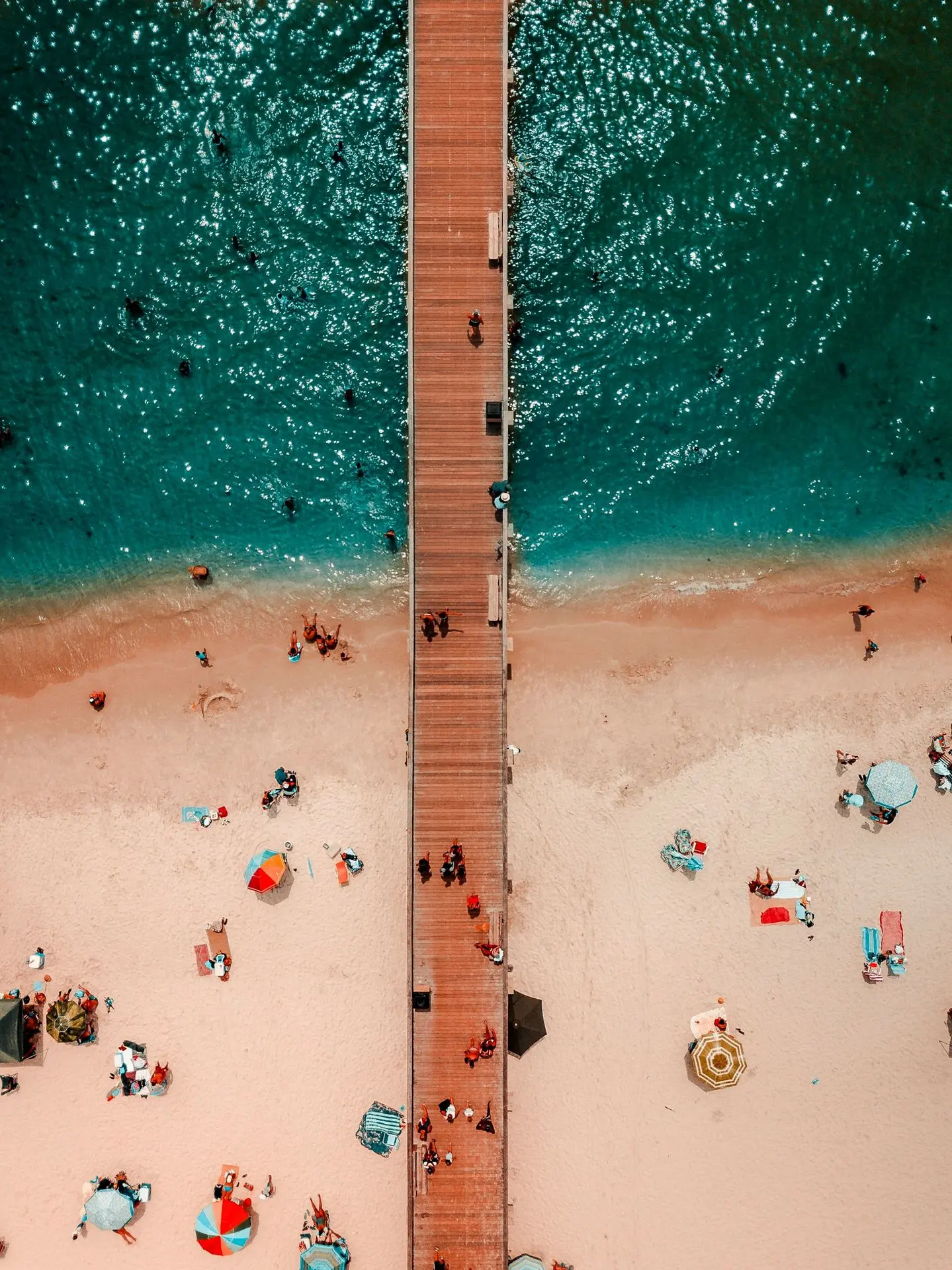 bird's-eye view photography of brown wooden dock on body of water